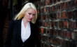 Pretty young blonde female posing against brick wall Pretty young blonde female posing against brick wall