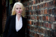 Beautiful young female posing near brick wall Beautiful young female posing near brick wall