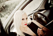 Sexy blonde girl sitting in a car. Closeup Sexy blonde girl sitting in a car. Closeup
