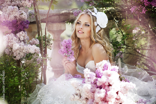 Photo: portrait of a bride with a bouquet of lilacs portrait of a bride with a bouquet of lilacs