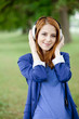 Young fashion girl with headphones at spring outdoor.