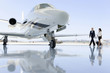 Photo : Two women walking towards aeroplane on runway Two women walking towards aeroplane on runway