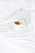 bed with a pillow and a cup of tea
