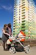 couple with carriage look at house