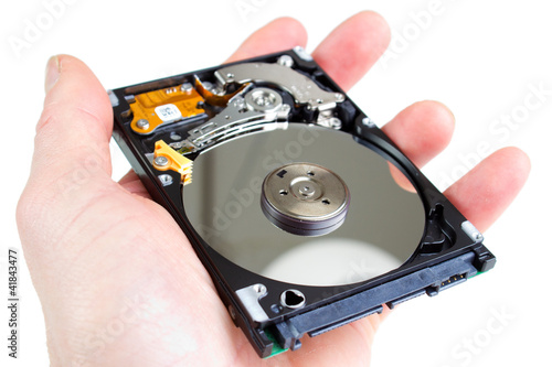 Photo: Computer hard drive without cover in hand Computer hard drive without cover in hand