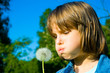 little girl blowing dandelion