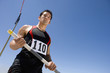 Photo: Young male athlete with pole, low angle view Young male athlete with pole, low angle view