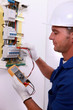 Electrician inspecting fuse box