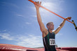 Photo: Young male athlete with hands on bar, low angle view (lens flare) Young male athlete with hands on bar, low angle view (lens flare)