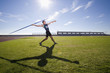 Photo: Male athlete preparing to throw javelin, low angle view (lens flare) Male athlete preparing to throw javelin, low angle view (lens flare)