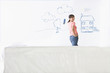 Smiling woman standing in front of house and family painted on living room wall
