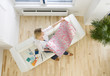 Woman on sofa looking at wallpaper sample