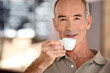 Elderly man drinking coffee