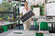 Foto: Serious teacher holding solar panel in school classroom Serious teacher holding solar panel in school classroom