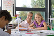 Foto: Teacher helping student study about wind turbines in school classroom Teacher helping student study about wind turbines in school classroom