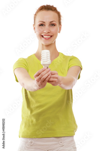 Photo: A woman with an energy-saving bulb in her hands A woman with an energy-saving bulb in her hands
