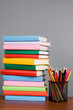 Colored pencils and a stack of books