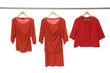 Fashion red clothing hanging on hangers