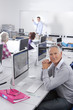 Smiling adult student studying in college evening class computer lab
