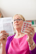 Senior woman with medication pills and prescription