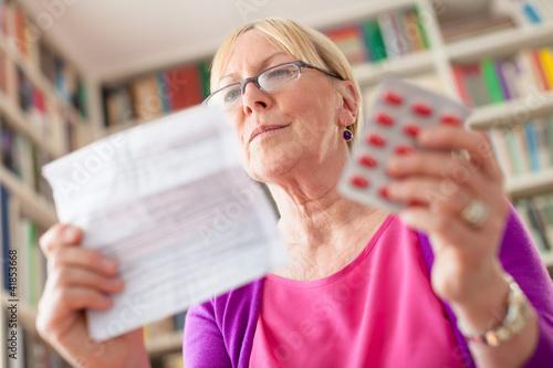 Photo: Senior woman with medication pills and prescription Senior woman with medication pills and prescription