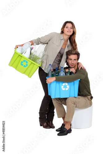 Photo: Couple recycling plastic bottles Couple recycling plastic bottles