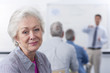 Smiling woman turning in seat during college evening class