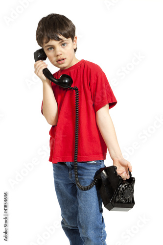 Photo: little boy on the phone, isolated on white background little boy on the phone, isolated on white background