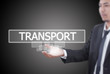 Businessman holding Transport word on the whiteboard.
