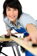 Female carpenter using workbench