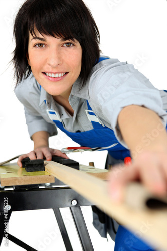 Photo: Female carpenter using workbench Female carpenter using workbench