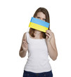 Attractive woman hides her face behind flag of Ukraine
