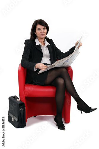 Photo: Businesswoman reading the newspaper Businesswoman reading the newspaper