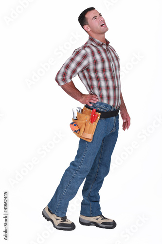 Photo: A handyman with his back hurting. A handyman with his back hurting.