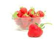 strawberries in a bowl and one of them is standing out