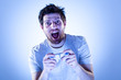 Amazed Man Playing Videogames with Gamepad