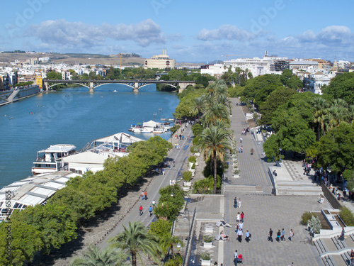 Photo: Tourists enjoying waterfront in Seville, Spain Tourists enjoying waterfront in Seville, Spain
