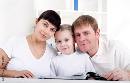Photo: Family reading a book together Family reading a book together