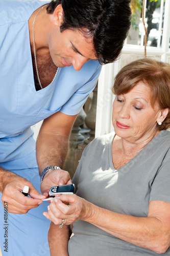 Photo: Male Nurse Measuring Glucose Level Male Nurse Measuring Glucose Level
