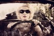 Retro woman behind steering wheel