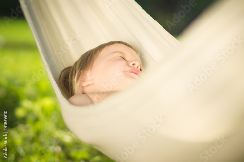 Photo: Adorable baby sleep quiet in hammock on sun Adorable baby sleep quiet in hammock on sun
