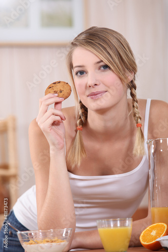 Photo: Woman eating a well balanced breakfast Woman eating a well balanced breakfast