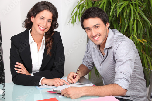 Photo: Customer signing contract agreement Customer signing contract agreement
