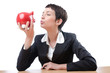 Woman and piggybank on white