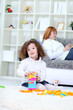 girl playing on floor in living room girl playing on floor in living room