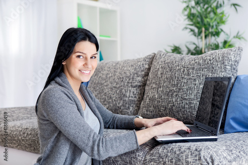 Foto: Woman working with computer at home Woman working with computer at home