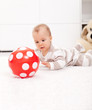 Baby girl with red ball