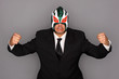 Man wearing a suit and luchador mask.