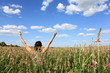 Happy girl in a field of spring flowers