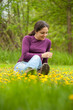 Young woman sitting on grass